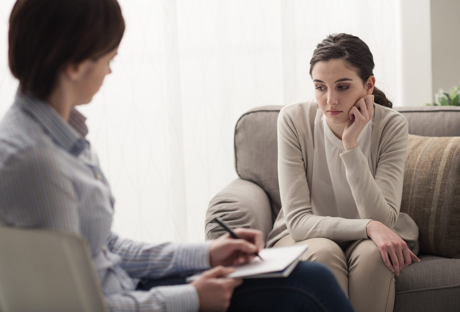 A woman talks to a therapist after a traumatic event.